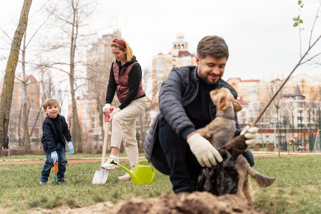 Man plating in the ground a small tree