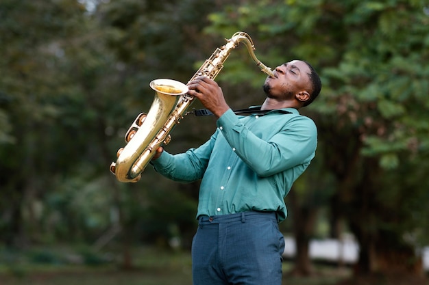 Бесплатное фото Мужчина играет на музыкальном инструменте в международный день джаза