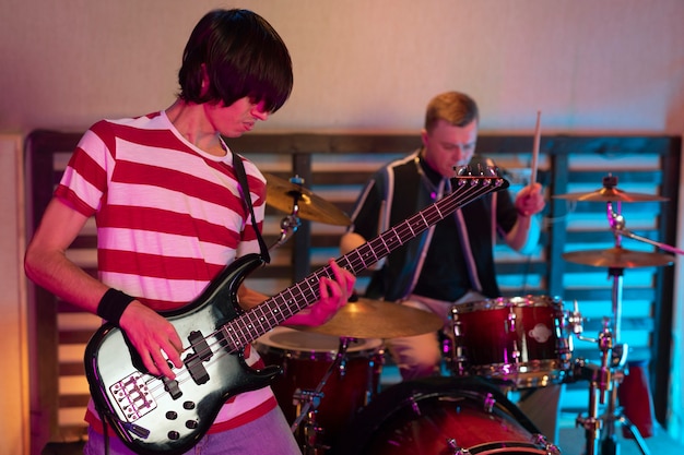 Free photo man playing the electric guitar at a live concert