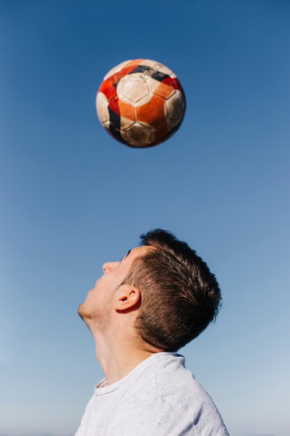 ビーチでサッカーをしている男