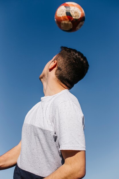 Man playing football at the beach