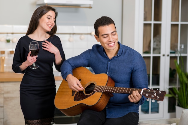 Man playing a song at guitar for his girlfriend