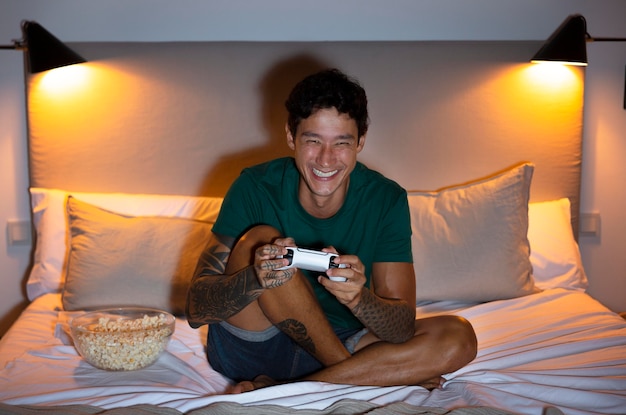 Free photo man playing a video game with his console