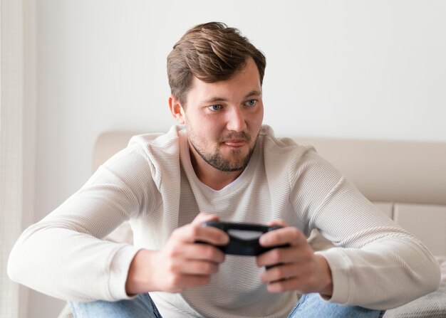 Man playing videogame at home