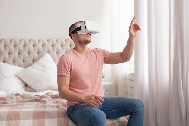 Man playing videogames while wearing virtual reality goggles