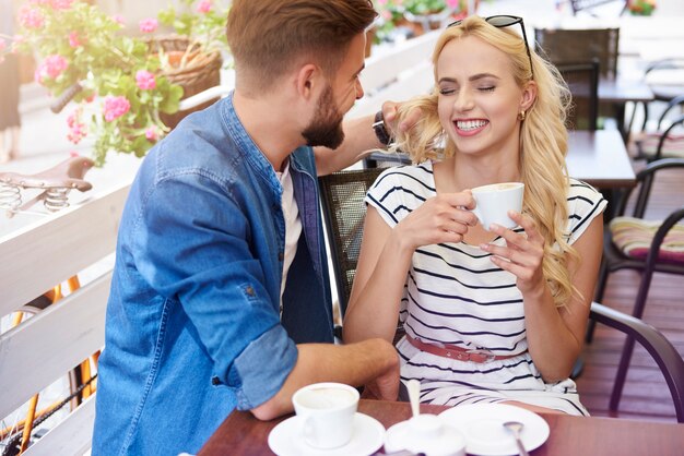 Man playing with his girlfriend's hair