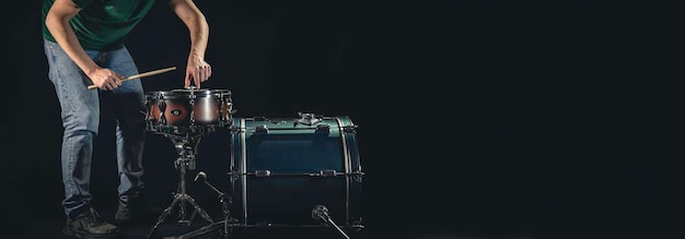 Free photo a man plays the snare drum against a dark background