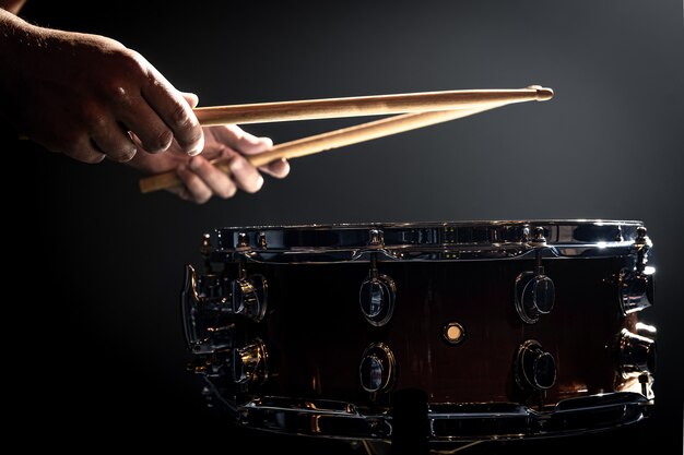 A man plays with sticks on a drum, a drummer plays a percussion instrument, copy space.