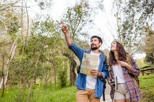 Man pointing at distance for woman