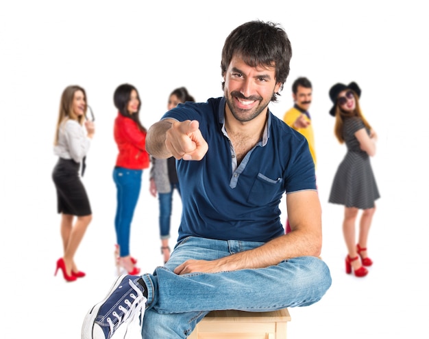 Man pointing to the front over white background