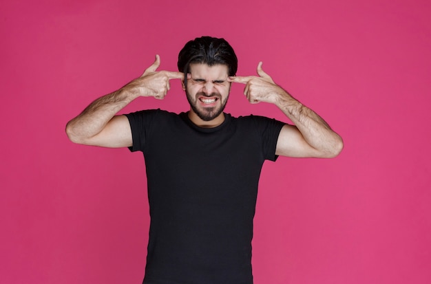 Man pointing his head and overthinking about something trying to remember