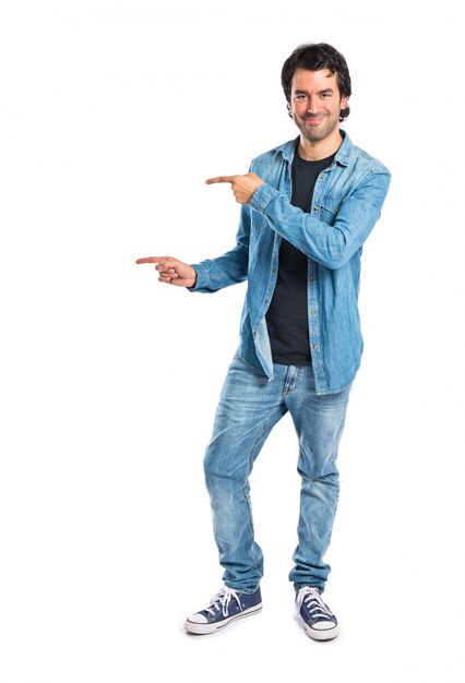 Man pointing lateral over white background
