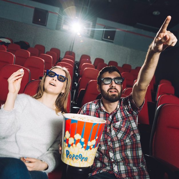 Man pointing at screen for woman