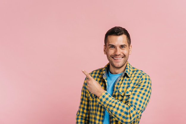 Man pointing up with pink background