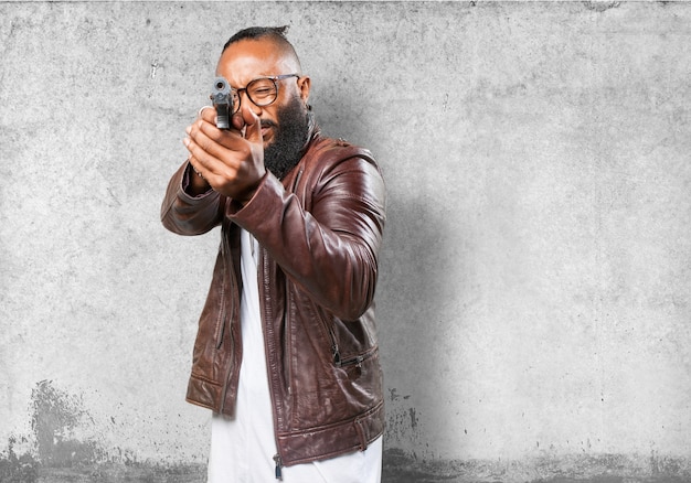 Free photo man pointing with a gun