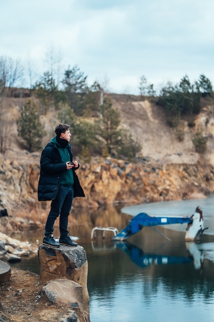 Free photo man poses in the quarry near the river