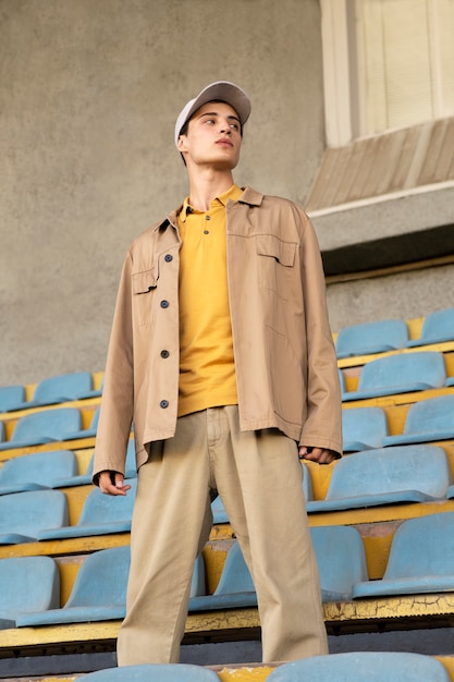 Man posing in grandstands full shot