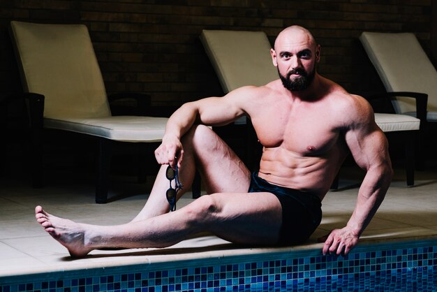 Man posing near swimming pool