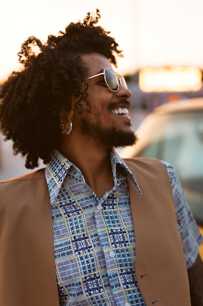 Man posing in retro style outdoors with sunglasses