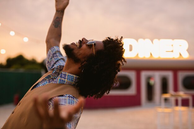 Man posing in retro style outdoors with sunglasses