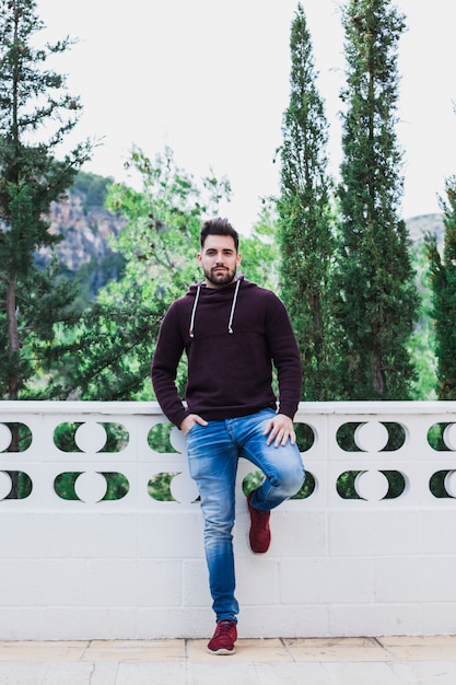 Man posing on terrace near forest