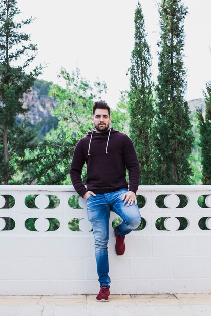 Man posing on terrace near forest