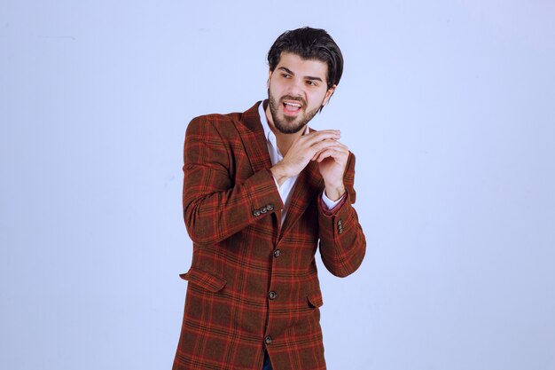 Man posing in trendy brown checked blazer