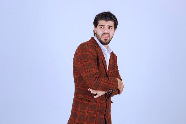 Man posing in trendy brown checked blazer