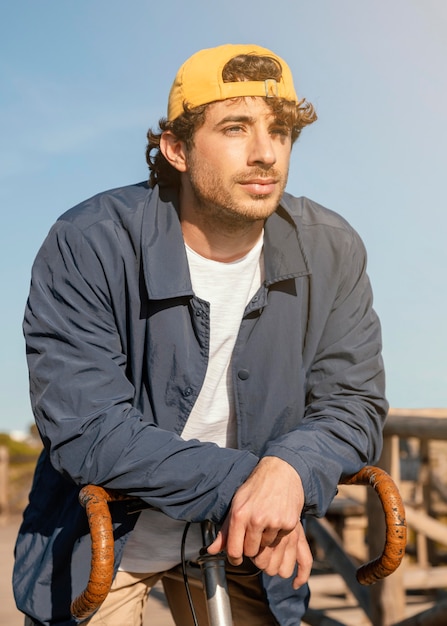 Man posing with bicycle medium shot