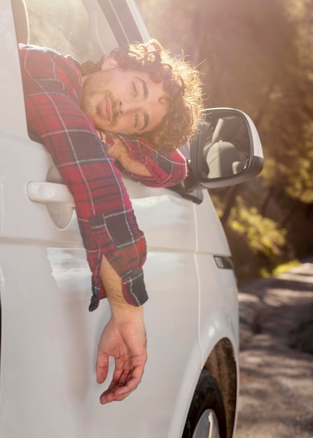 Free photo man posing with car