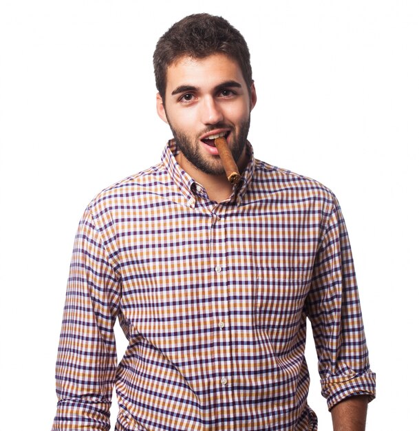 Man posing with cigar in studio. 