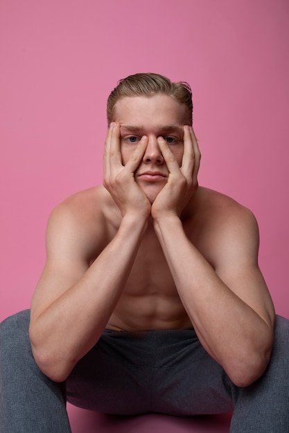 Free photo man posing with pink background front view