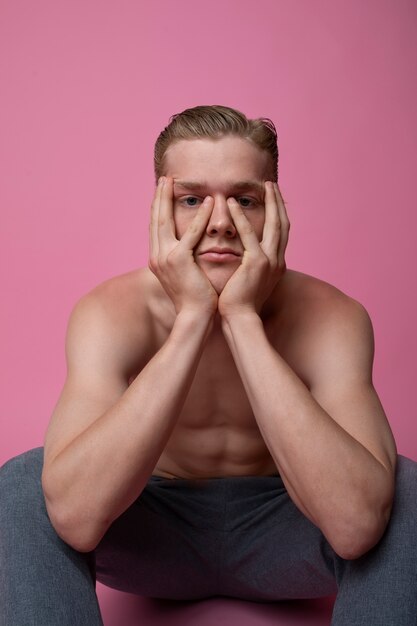 Man posing with pink background front view