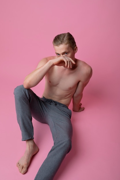 Man posing with pink background high angle