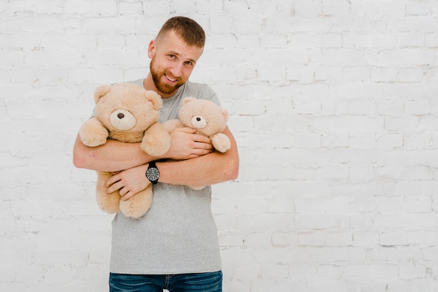 Free photo man posing with plush toys