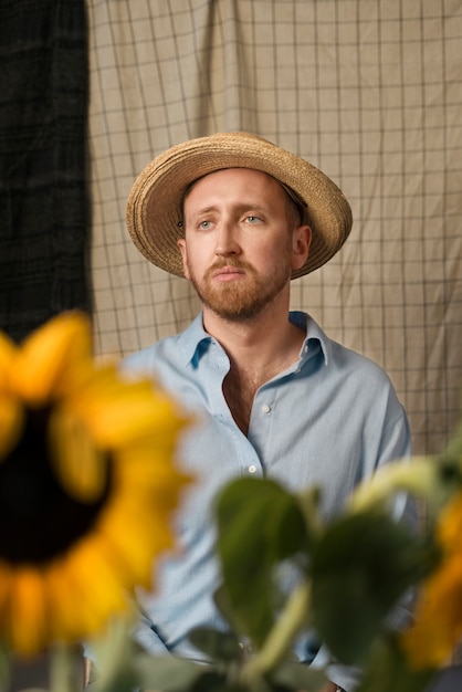 Man posing with sunflowers medium shot