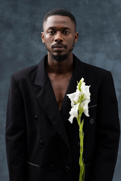 Man posing with white flower front view