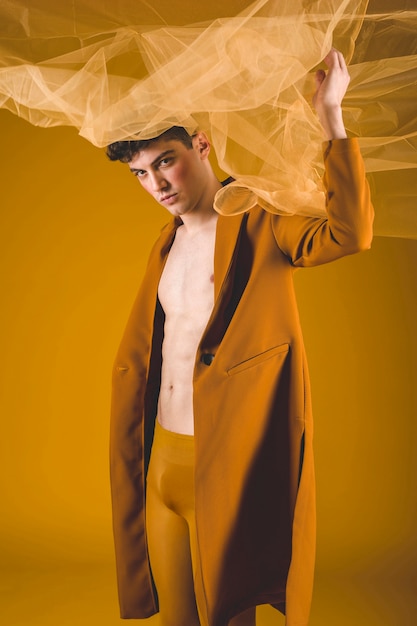 Man posing with yellow cloth