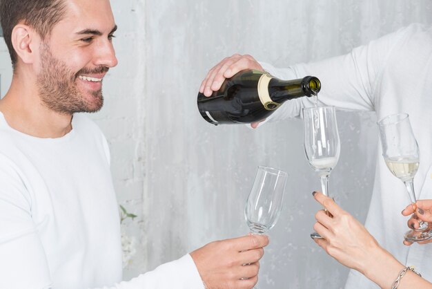 Man pouring champagne in glasses on party