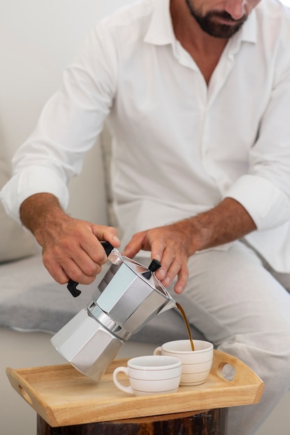 Man pouring coffee for him and his girlfriend