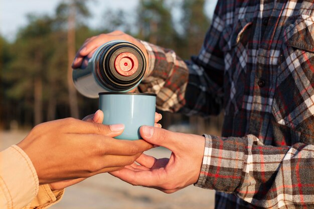 Man pouring coffee for his girlfriend close-up