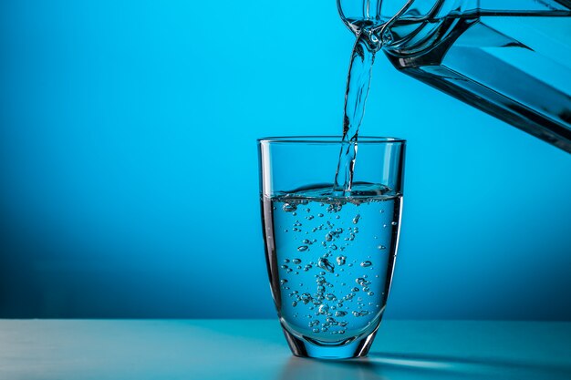 Man pours water from glass