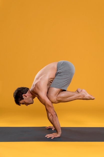 Man practicing balance yoga pose