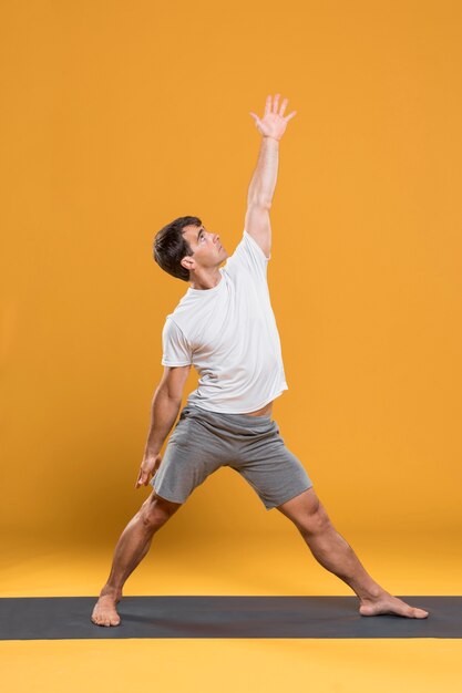 Man practicing yoga on mat