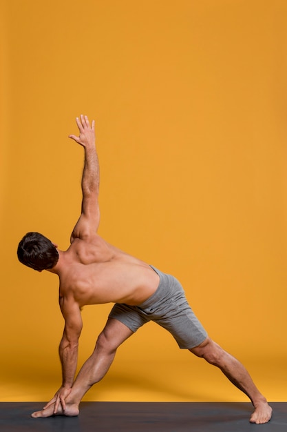 Free photo man practicing in yoga position