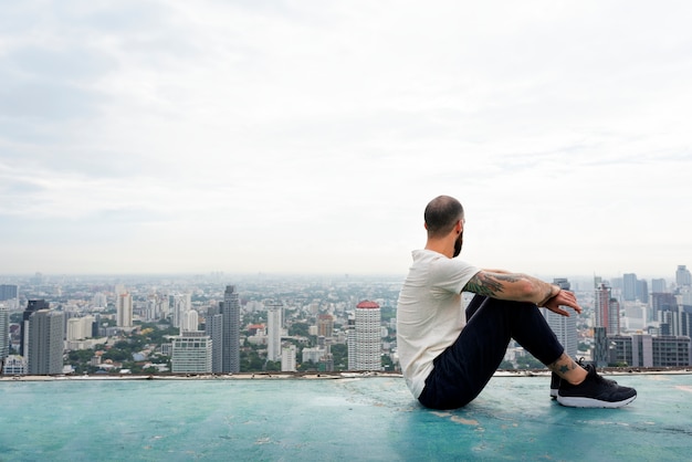 Man practicing yoga on the rooftop