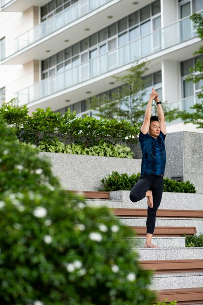 Man practicing yoga on steps