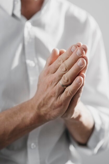 Man praying alone at home close-up