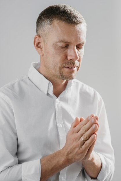 Man praying alone indoors