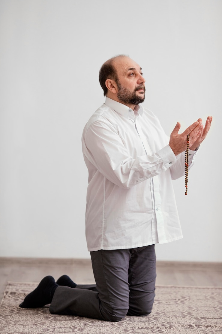 Free Photo man praying on the floor indoors
